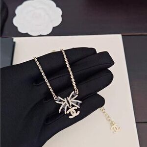 CHANEL Gold Necklace with Silver Bow Charm